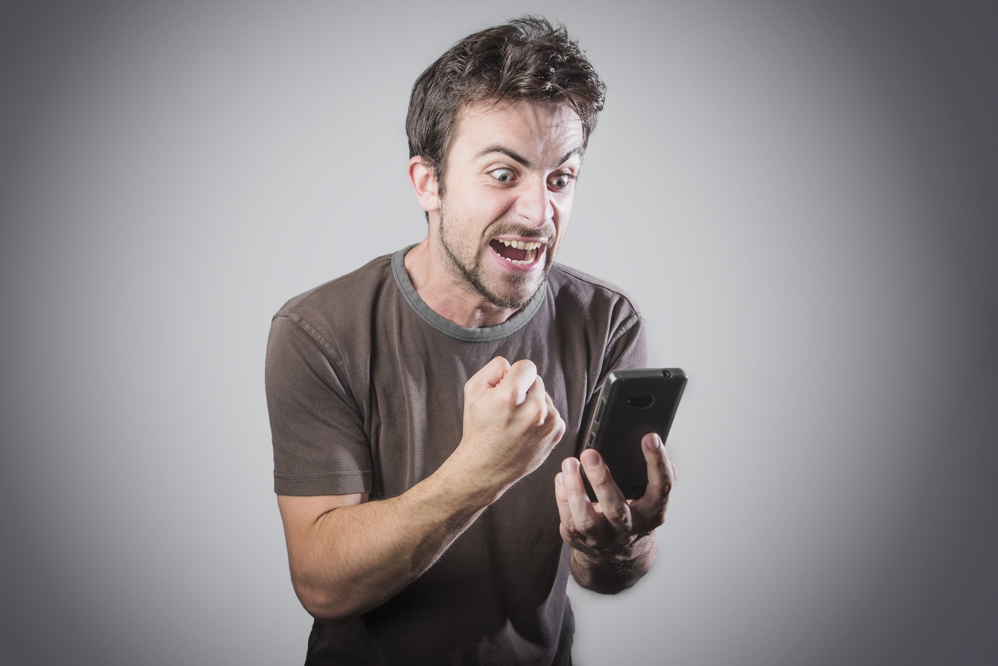 Angry man holding phone